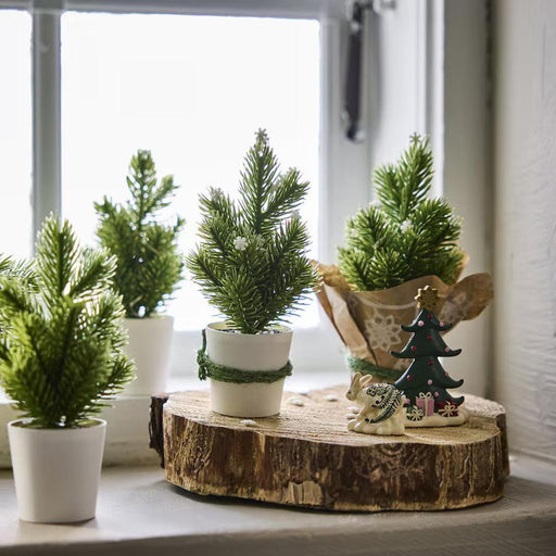 IKEA VINTERFINT artificial green Christmas tree 17cm placed on a shelf with festive ornaments