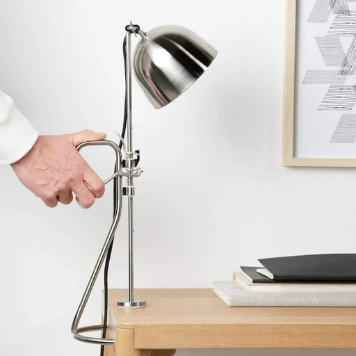 IKEA RÅVAROR clamp lamp mounted vertically on shelf directing focused light downward