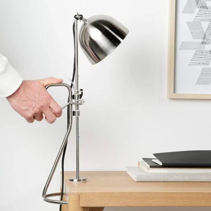 IKEA RÅVAROR clamp lamp mounted vertically on shelf directing focused light downward