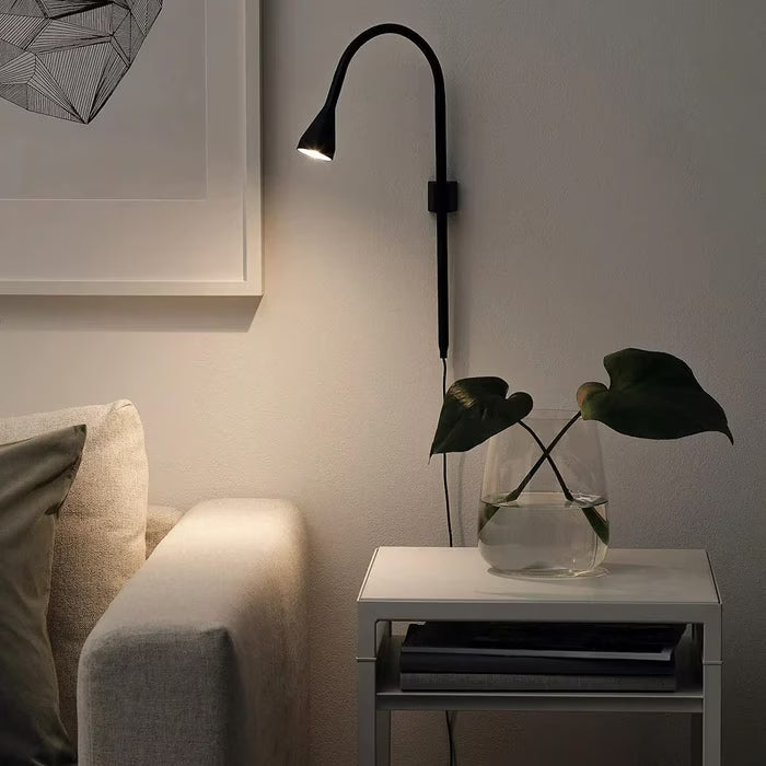 IKEA NÄVLINGE black LED clamp spotlight wall-mounted position showing adjustable arm angle