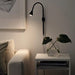 IKEA NÄVLINGE black LED clamp spotlight wall-mounted position showing adjustable arm angle
