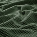 IKEA INDIRA grey-green cotton bedspread close-up showing woven texture and folds