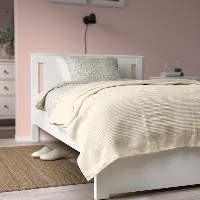 IKEA INDIRA bedspread draped on a bed, showcasing its natural unbleached cotton texture 50581058