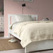 IKEA INDIRA bedspread draped on a bed, showcasing its natural unbleached cotton texture 50581058