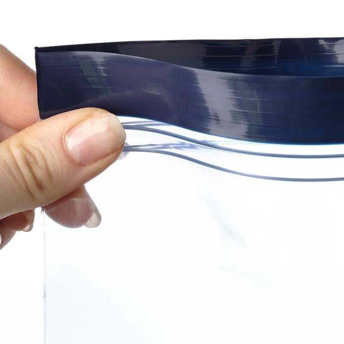 Hand holding transparent IKEA ISTAD blue patterned bag demonstrating the flexible double-seal closure