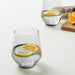 Two IKEA IVRIG glasses with lemon and orange slices on white surface, styled drinks setting
