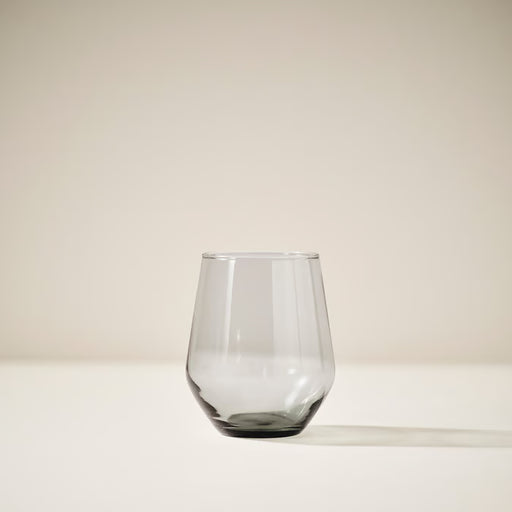 Single IKEA IVRIG grey stemless glass standing alone, showing elegant rounded bowl and clear finish