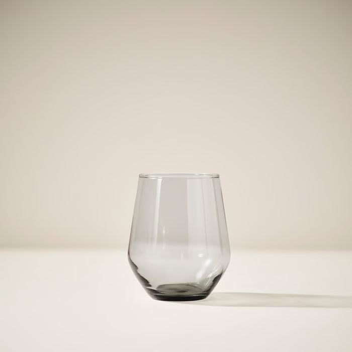 Single IKEA IVRIG grey stemless glass standing alone, showing elegant rounded bowl and clear finish