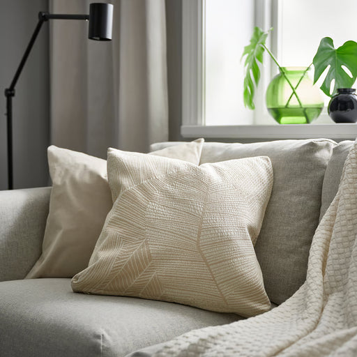 IKEA JÄTTEGRAN off-white cushion styled on grey couch with pillows and blanket