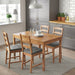 IKEA JUSTINA grey chair pads on dining chairs in a cosy compact kitchen dining set