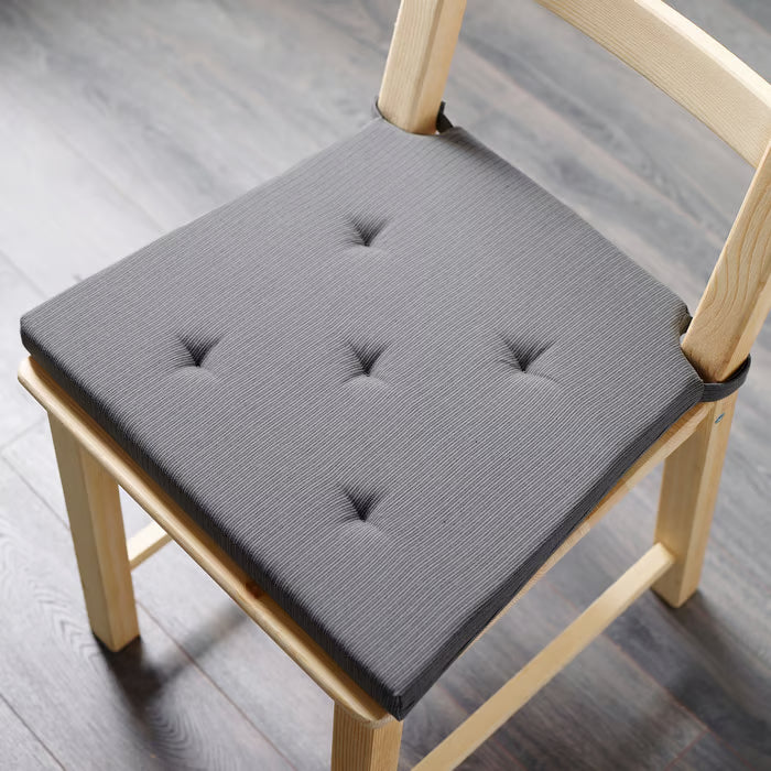Top view of IKEA JUSTINA grey cotton chair pad showing square shape and tufted surface detail