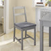 IKEA JUSTINA grey padded seat cushion on a wooden dining chair with simple frame