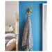  IKEA KÄMPIG brass-colour hook in bedroom with blue wall and leopard-print towel hanging