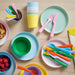  IKEA KALAS kids bowls in mixed colours shown alongside snacks and drinks lifestyle setting