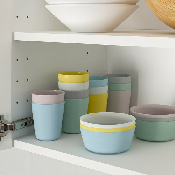 IKEA KALAS mixed colour kids plates bowls and utensils stacked showing compact storage design