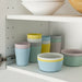 IKEA KALAS mixed colour kids plates bowls and utensils stacked showing compact storage design