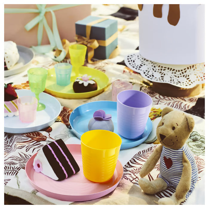 Colourful children's table setting with IKEA KALAS mugs plates bowls and toy food playful arrangement