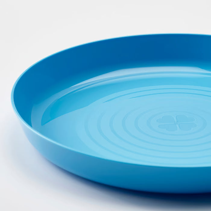 Close-up of IKEA KALAS mixed colour kids plates showing high-edge rim and stackable design detail