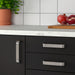 IKEA KALERUM stainless steel handle fitted on modern kitchen cabinet door easy-grip view