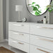 White dresser with IKEA KALERUM silver handles round mirror and decor on top