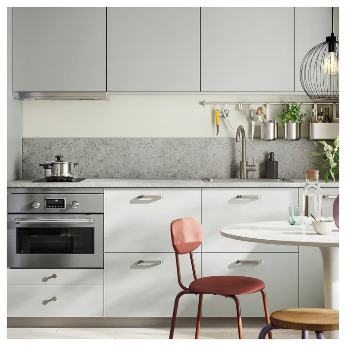 IKEA KALERUM stainless steel handles on grey kitchen cabinet doors with oven and red chair