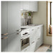 IKEA KALERUM handles on light grey kitchen cabinets with stainless steel appliances minimalist interior