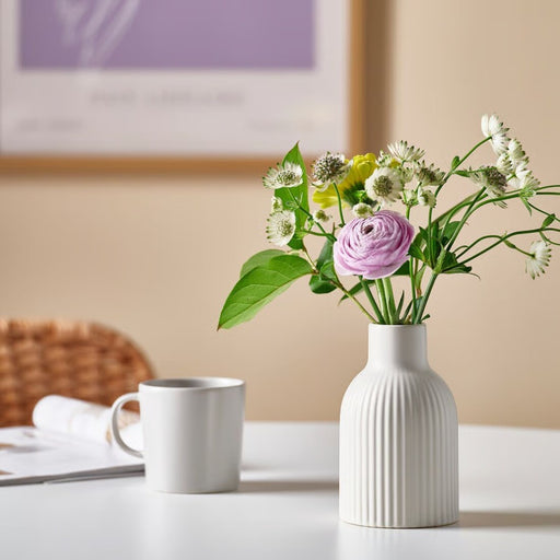 Sleek IKEA KAPKASTANJ vase in soft off-white, standing 15 cm (5¾") high, designed to hold fresh or dried flowers while complementing modern home decor.
