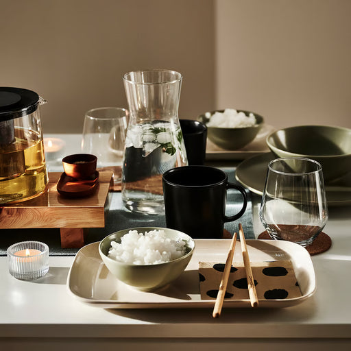 IKEA KARAFF glass carafe on a table setting with tea cups and bowls styled for a home breakfast spread