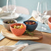 Close-up of IKEA KEJSERLIG stoneware bowl showing pigmented glaze texture and mixed colour finish