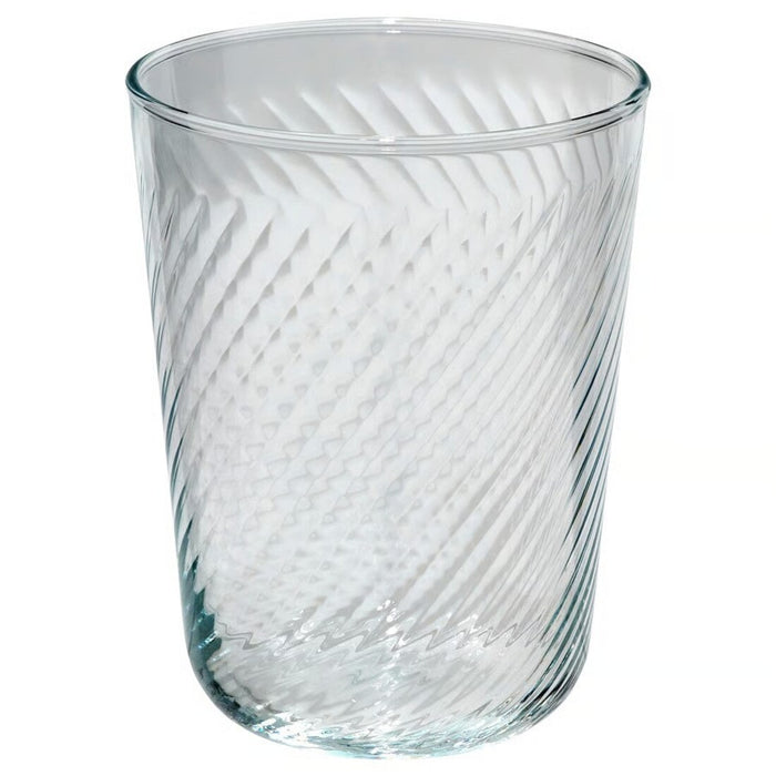 Clear glass tumbler with textured design on a white background