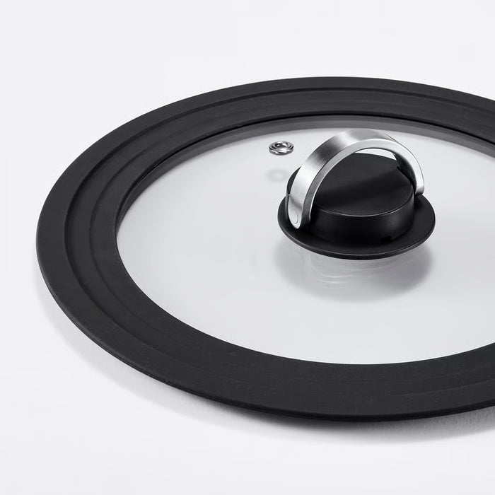 Close-up of IKEA KLOCKREN glass lid showing silicone rim and stainless steel handle