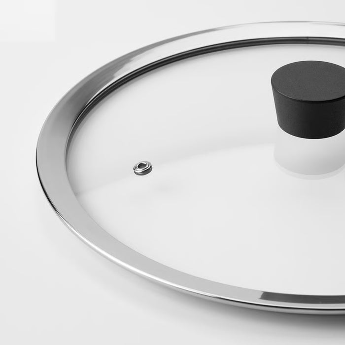 Close-up of IKEA KLOCKREN glass lid showing stainless steel rim and black phenolic handle