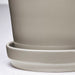 Close-up of IKEA KLOTLÖNN light grey glazed stoneware planter and saucer finish