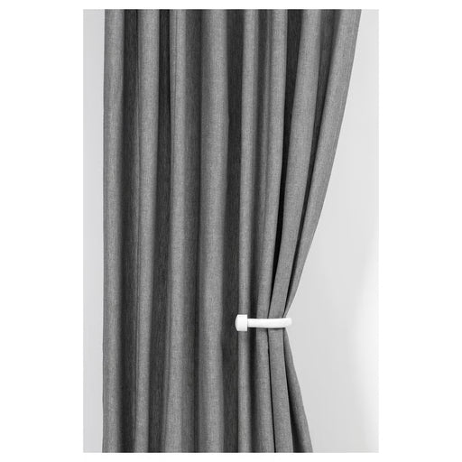  IKEA KNÖLFLY white tie-back holding grey curtains in living room