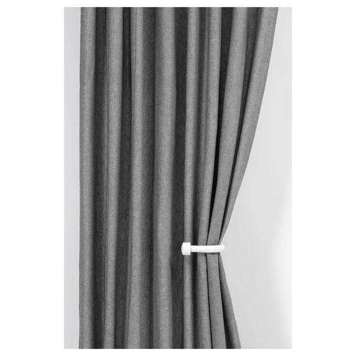  IKEA KNÖLFLY white tie-back holding grey curtains in living room