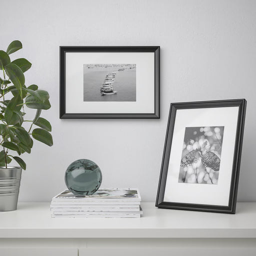  IKEA KNOPPÄNG black frames displaying sailor and butterfly prints in a styled modern home decor setup