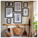 IKEA KNOPPÄNG black frames arranged in a gallery wall above a wooden peg rack with baskets