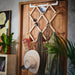 Close-up of IKEA KOMPISHÄNG pine door hanger hooks holding beaded necklaces