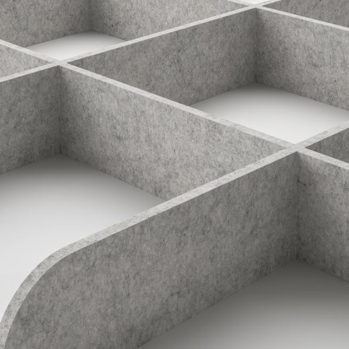 Close-up of IKEA KOMPLEMENT light grey tray divider showing curved compartments and textured felt surface