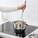 Person mashing potatoes on stovetop with IKEA KONCIS long-handle stainless steel masher