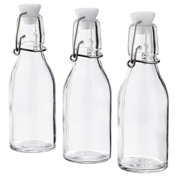 IKEA KORKEN clear glass bottles with white stoppers and metal clips set of 3 front view #30476336