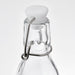 IKEA KORKEN clear glass bottle close-up showing white rubber stopper and stainless steel wire clasp