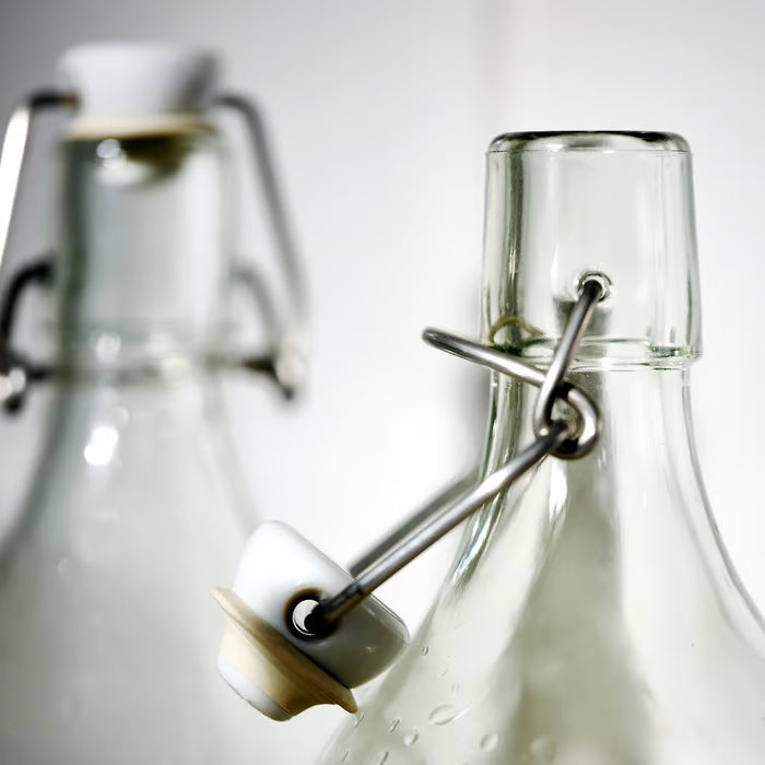  IKEA KORKEN glass bottle with airtight stopper close-up showing clamp and rubber seal detail