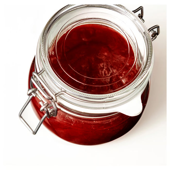 Close-up of IKEA KORKEN glass jar filled with red jam, metal clasp sealed airtight