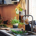  IKEA KORKEN glass jars on kitchen counter storing dried goods and herbs near a sunlit window