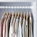 IKEA KRÄNGA wooden hangers in wardrobe holding women's tops showing grooves preventing clothes from slipping