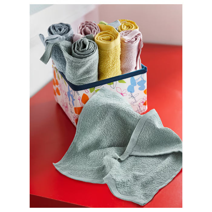 IKEA KRAMA mixed colour washcloths rolled and arranged in decorative box one laid flat on red surface