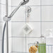  IKEA KROKFJORDEN suction cup hooks holding grey towels on white tiled bathroom wall