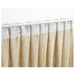 Close-up of pleated curtains with IKEA KRONILL white heading tape and metal curtain hooks attached
