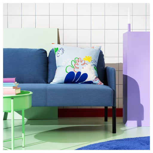 IKEA KRYPKORNELL  multicoloured floral cushion cover on a blue sofa